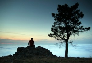 Man on rock on the top of the mountain